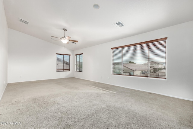 carpeted spare room with ceiling fan and lofted ceiling