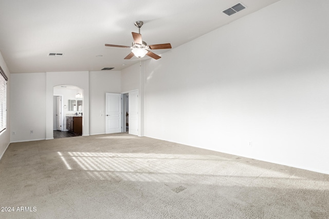 empty room featuring ceiling fan and carpet floors