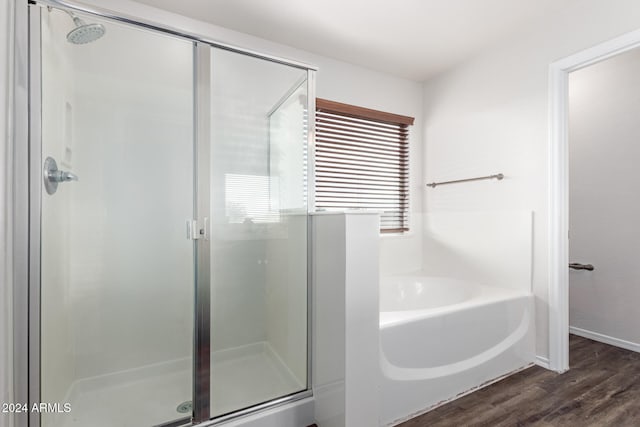 bathroom featuring hardwood / wood-style flooring and independent shower and bath