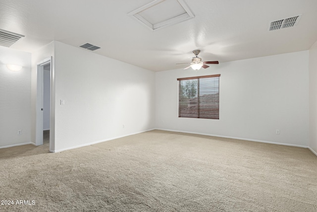 carpeted spare room with ceiling fan