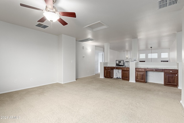 unfurnished living room with ceiling fan and light colored carpet