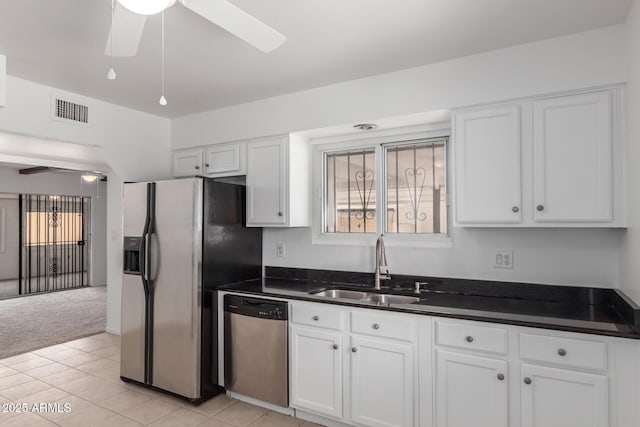 1515 N Saguaro Dr, Tempe, AZ 85288 - kitchen with stainless steel appliances, ceiling fan, a sink, and white cabinetry