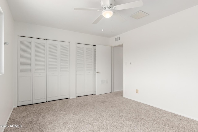 1515 N Saguaro Dr, Tempe, AZ 85288 - unfurnished bedroom with carpet floors, two closets, baseboards, and ceiling fan
