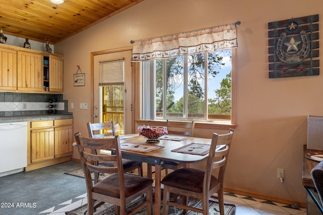 tiled dining area featuring vaulted ceiling and wood ceiling