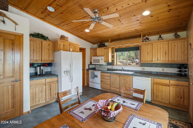 kitchen featuring dark tile patterned flooring, white appliances, sink, lofted ceiling, and ceiling fan