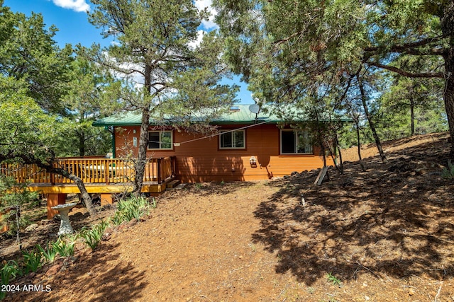 back of house featuring a wooden deck