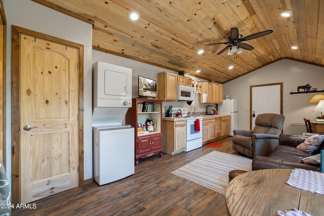 kitchen featuring vaulted ceiling, white appliances, dark hardwood / wood-style flooring, stacked washer / dryer, and ceiling fan