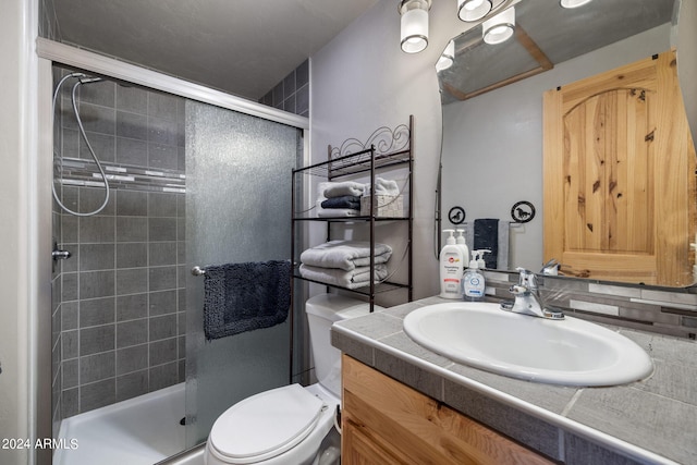 bathroom with vanity, toilet, an enclosed shower, and tasteful backsplash