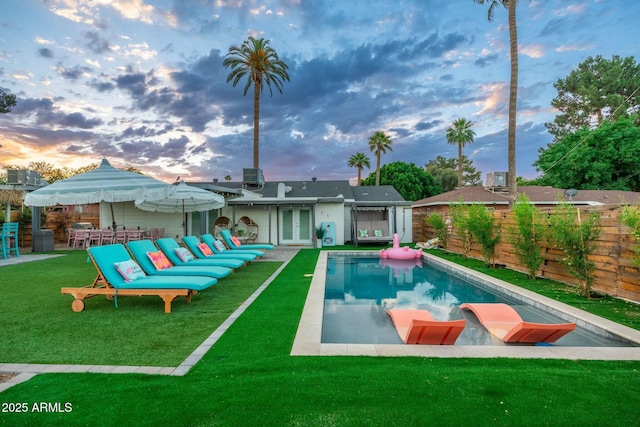 4036 N 40th Pl, Phoenix, AZ 85018 - back of house at dusk with french doors, a fenced backyard, and a patio