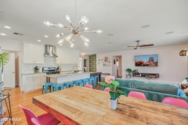 4036 N 40th Pl, Phoenix, AZ 85018 - dining room with a chandelier, light wood finished floors, recessed lighting, and ceiling fan