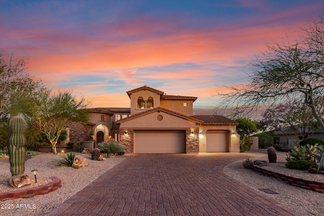 9753 E Suncrest Rd, Scottsdale, AZ 85262 - mediterranean / spanish home featuring stucco siding, an attached garage, stone siding, and a tiled roof