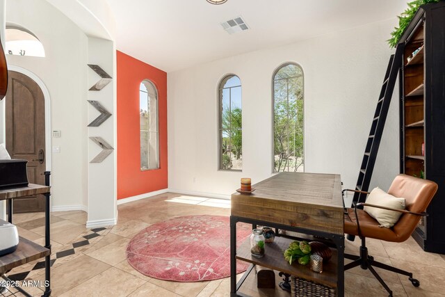 9753 E Suncrest Rd, Scottsdale, AZ 85262 - office featuring light tile patterned floors, arched walkways, baseboards, and inlaid floor details