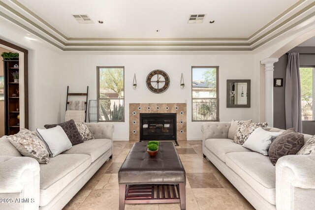 9753 E Suncrest Rd, Scottsdale, AZ 85262 - living room featuring ornate columns, a tray ceiling, a fireplace, and crown molding