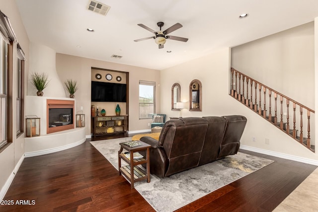 9753 E Suncrest Rd, Scottsdale, AZ 85262 - living area featuring a ceiling fan, wood finished floors, a glass covered fireplace, stairs, and recessed lighting