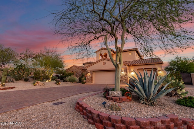 9753 E Suncrest Rd, Scottsdale, AZ 85262 - mediterranean / spanish-style house featuring stucco siding, driveway, an attached garage, and a tiled roof