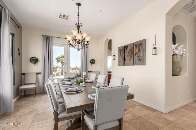 9753 E Suncrest Rd, Scottsdale, AZ 85262 - dining area with arched walkways, a chandelier, baseboards, and light tile patterned floors