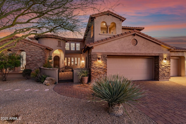 9753 E Suncrest Rd, Scottsdale, AZ 85262 - mediterranean / spanish home with stone siding, stucco siding, a gate, and a garage