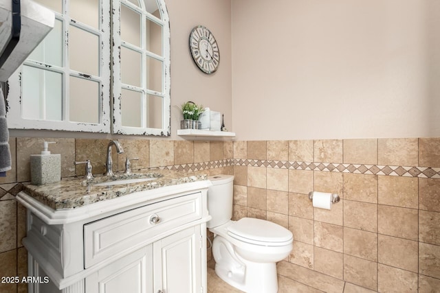 9753 E Suncrest Rd, Scottsdale, AZ 85262 - bathroom featuring tile walls, vanity, toilet, and a wainscoted wall