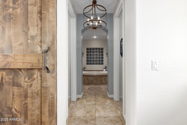 9753 E Suncrest Rd, Scottsdale, AZ 85262 - hallway featuring a chandelier, baseboards, and light tile patterned floors