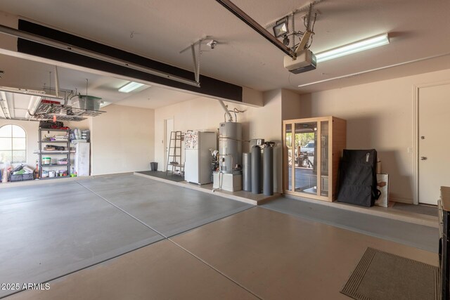 9753 E Suncrest Rd, Scottsdale, AZ 85262 - garage with water heater, freestanding refrigerator, and a garage door opener