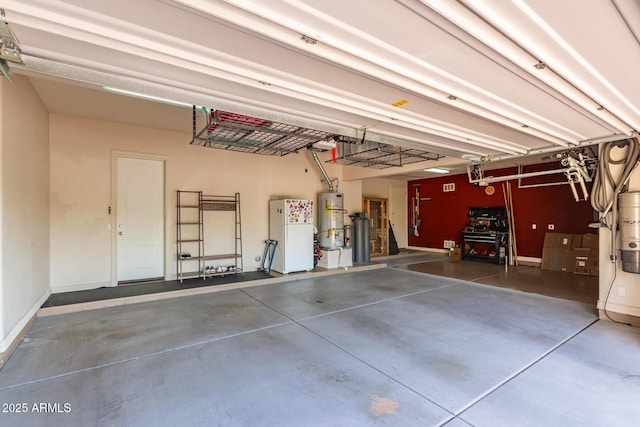 9753 E Suncrest Rd, Scottsdale, AZ 85262 - garage with gas water heater, freestanding refrigerator, and baseboards