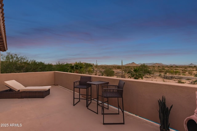 9753 E Suncrest Rd, Scottsdale, AZ 85262 - patio terrace at dusk with a mountain view and a balcony