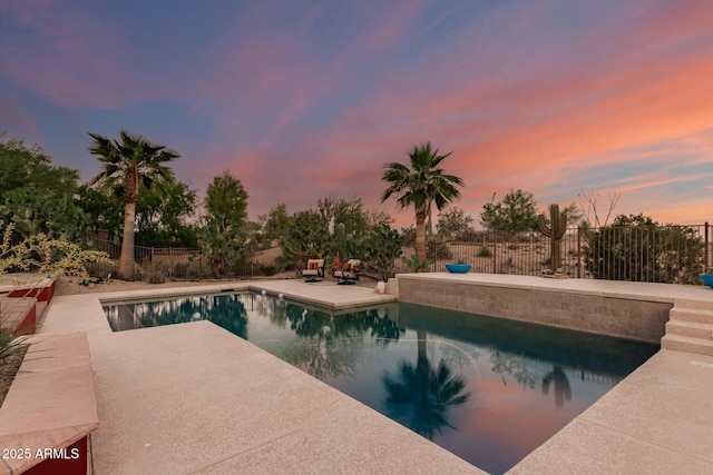 9753 E Suncrest Rd, Scottsdale, AZ 85262 - pool at dusk with a patio area and a fenced backyard