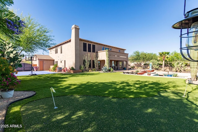 9753 E Suncrest Rd, Scottsdale, AZ 85262 - rear view of property with a putting green, a chimney, stucco siding, and a lawn