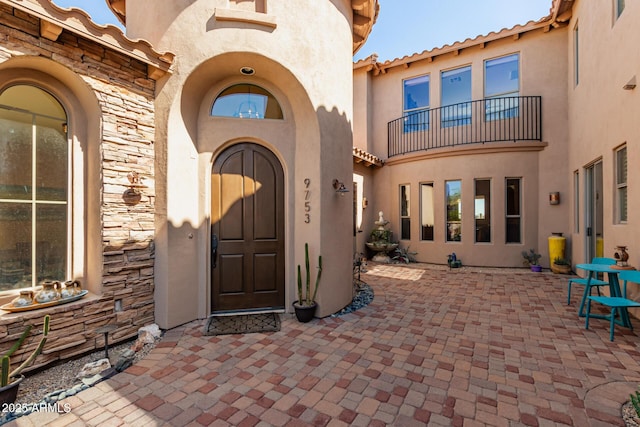 9753 E Suncrest Rd, Scottsdale, AZ 85262 - doorway to property with stone siding, stucco siding, a patio, and a tile roof