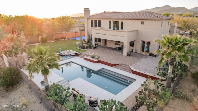 9753 E Suncrest Rd, Scottsdale, AZ 85262 - rear view of house with stucco siding, a tiled roof, a chimney, a fenced backyard, and outdoor lounge area