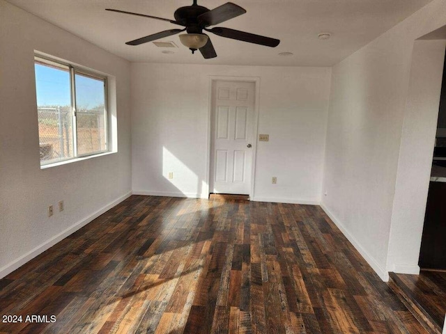 empty room featuring dark hardwood / wood-style floors and ceiling fan