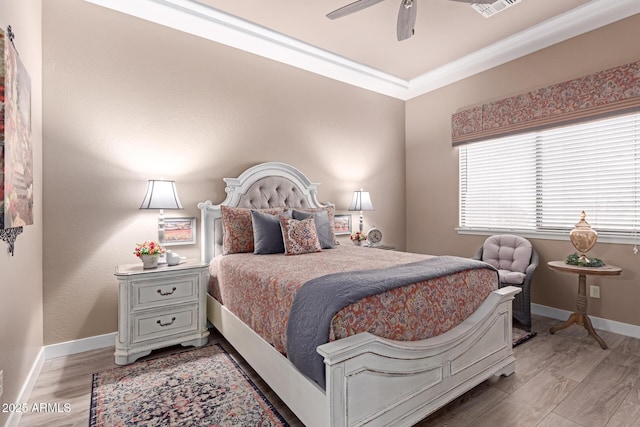 bedroom with visible vents, crown molding, ceiling fan, baseboards, and light wood-type flooring