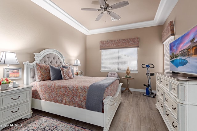 bedroom with baseboards, light wood-style floors, ceiling fan, and crown molding