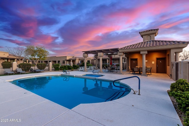 pool at dusk featuring a patio area, a community pool, a pergola, and fence