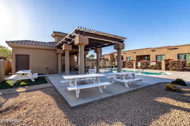 exterior space featuring a community pool, fence, and a pergola