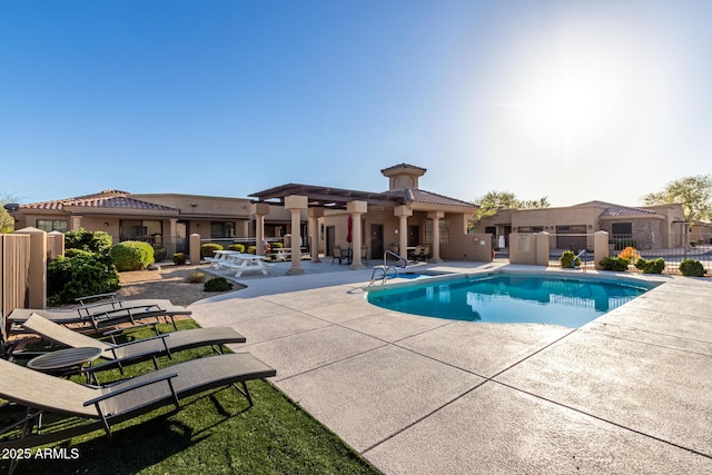 pool with fence and a patio area