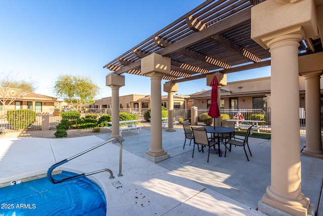 view of patio / terrace with a residential view, a pergola, outdoor dining area, and fence