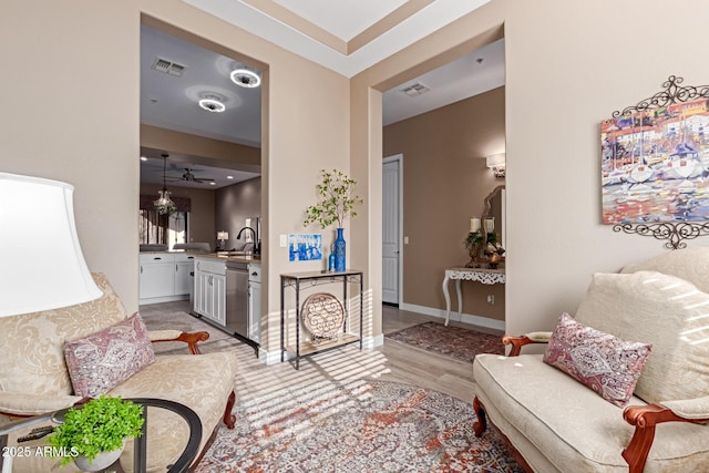 living area with visible vents, baseboards, and light wood-style floors