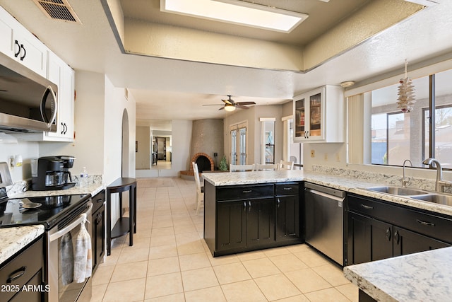 kitchen with white cabinetry, sink, a raised ceiling, and appliances with stainless steel finishes