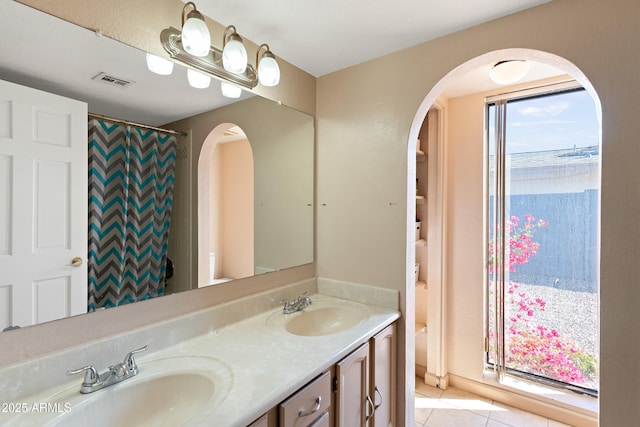 bathroom with tile patterned floors, a shower with shower curtain, and vanity