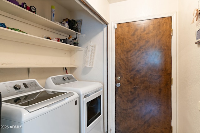 laundry area featuring washing machine and clothes dryer