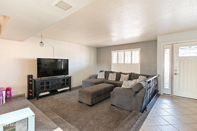 living room with tile patterned flooring, plenty of natural light, and a textured ceiling