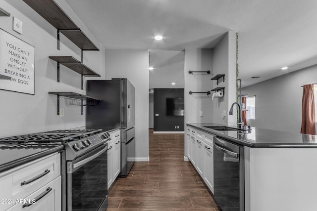 kitchen with appliances with stainless steel finishes, sink, dark wood-type flooring, and white cabinets