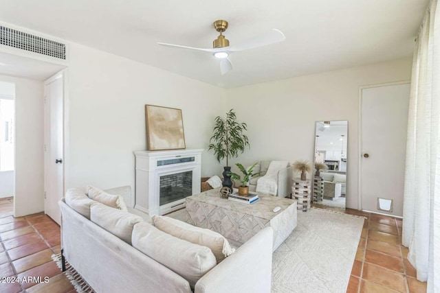 living room featuring ceiling fan and light tile patterned flooring