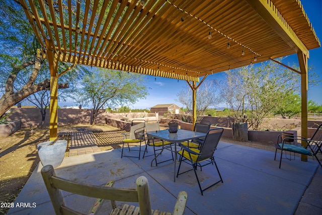 view of patio featuring a pergola, outdoor dining area, and a fenced backyard