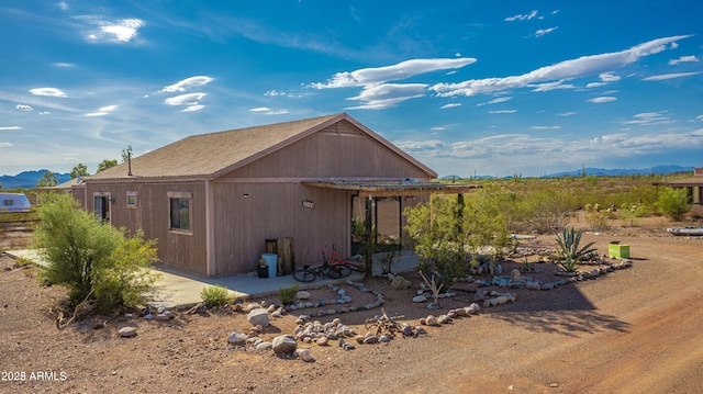 rear view of house featuring a patio area and a mountain view