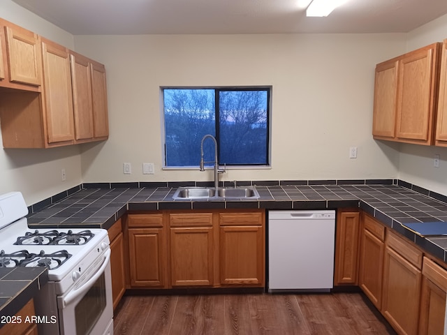 kitchen with a sink, dark wood-style flooring, tile countertops, and white appliances