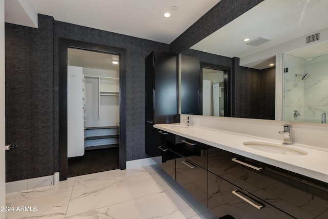 bathroom with vanity and a tile shower