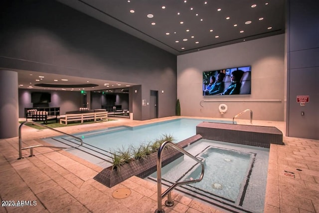 view of pool featuring an indoor hot tub