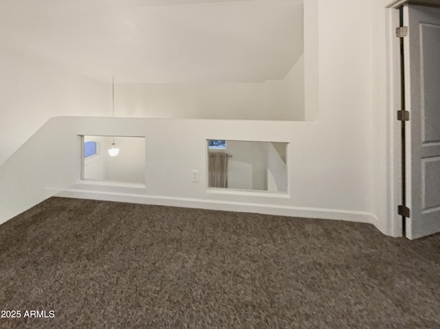 13033 W Avalon Dr, Avondale, AZ 85392 - interior space with dark colored carpet and vaulted ceiling